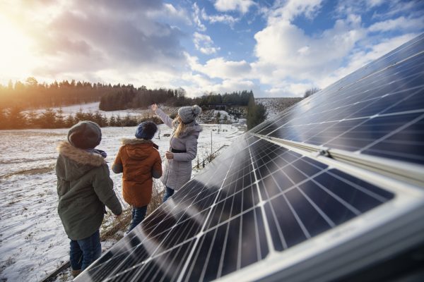Mother and two little boys standing by solar panels and discussing about the sustainable technology. Sunny winter day.
Shot with Canon R5